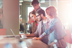 People in front of a laptop